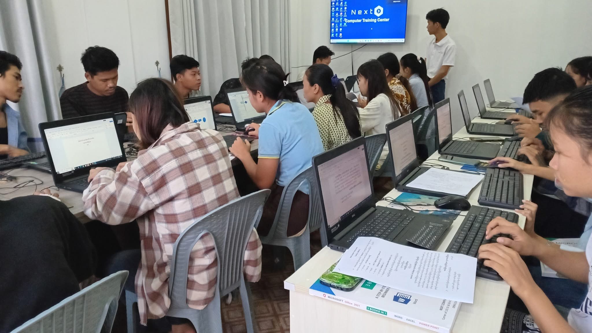 Students learning Microsoft Office in a computer training class